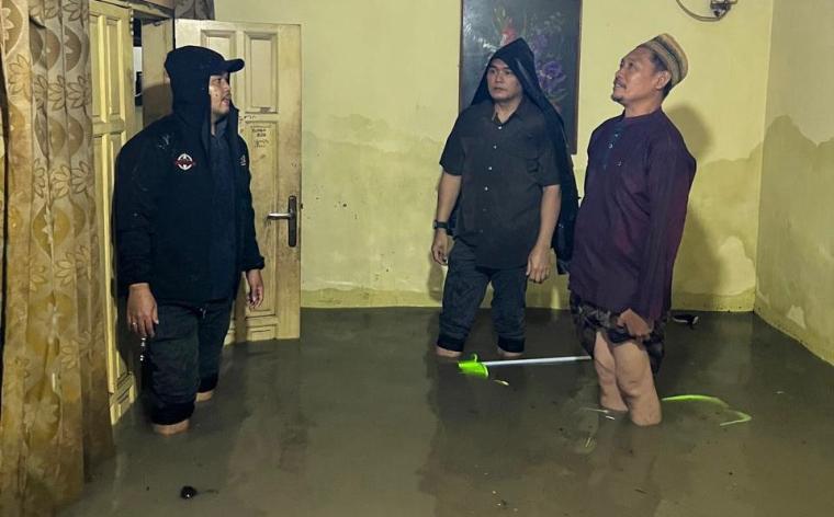 Kadis Perkim Kota Serang Nofriady didampingi Kabid Perumahan Mufasir bersama warga di lokasi banjir.