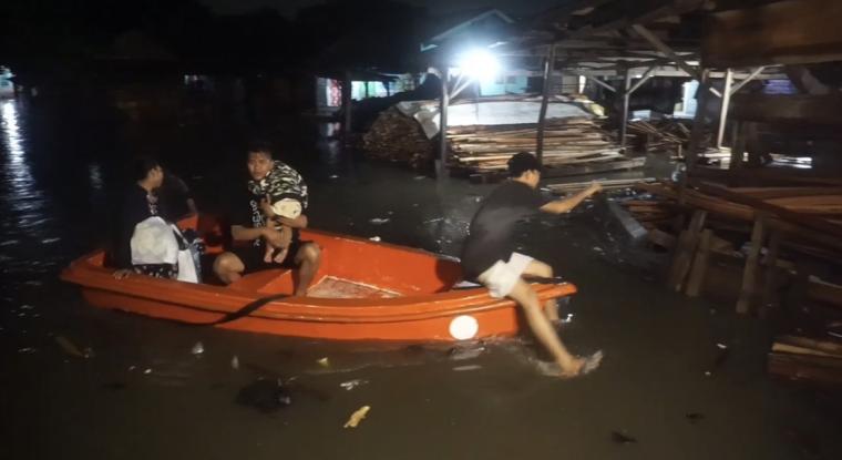 Sejumlah warga terdampak banjir saat dievakuasi.